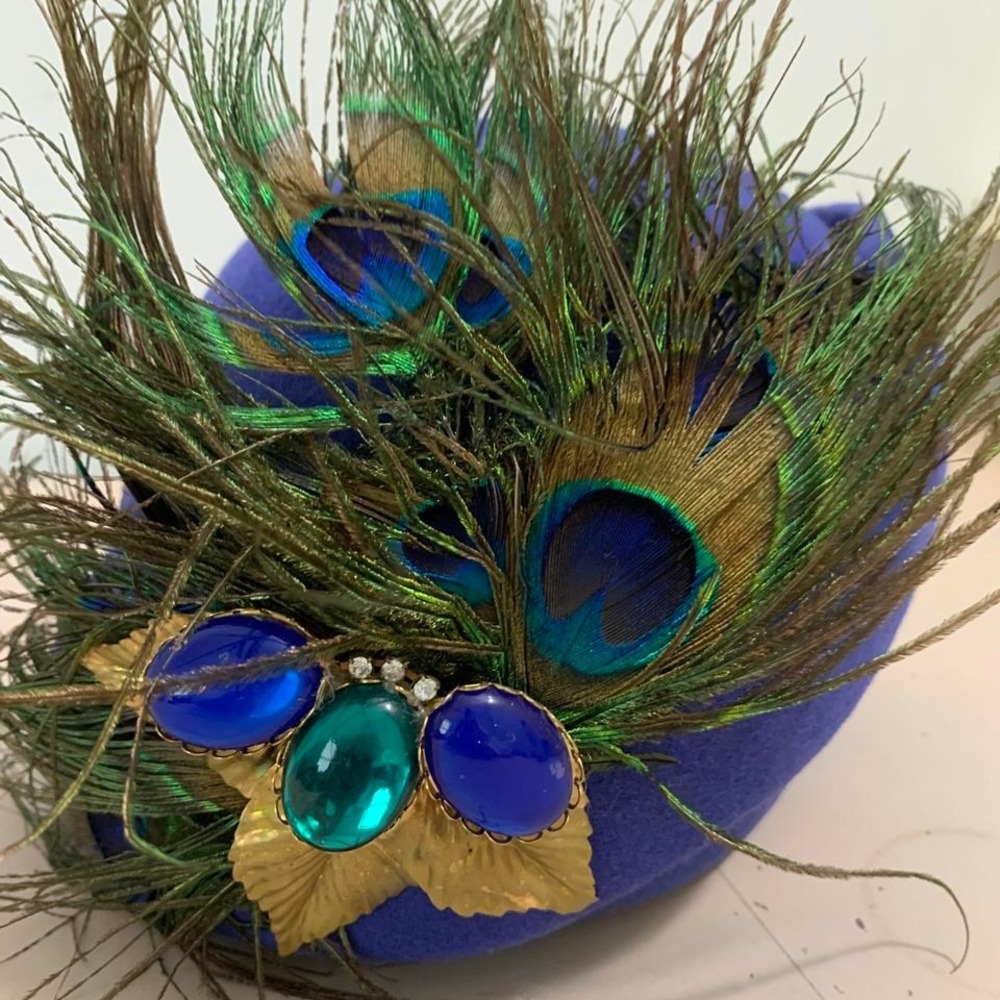 Vintage 1950s blue peacock feather mask with green and blue accents